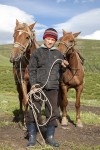 12063604-Казахский-мальчик-держит-поводья-двух-лошадей-на-паст�